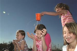 children playing with leaky cup of water